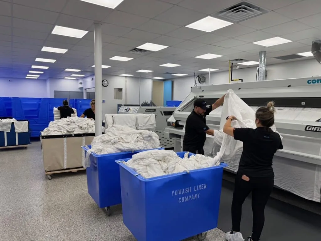 YoWash Linen staff sorting and handling linens