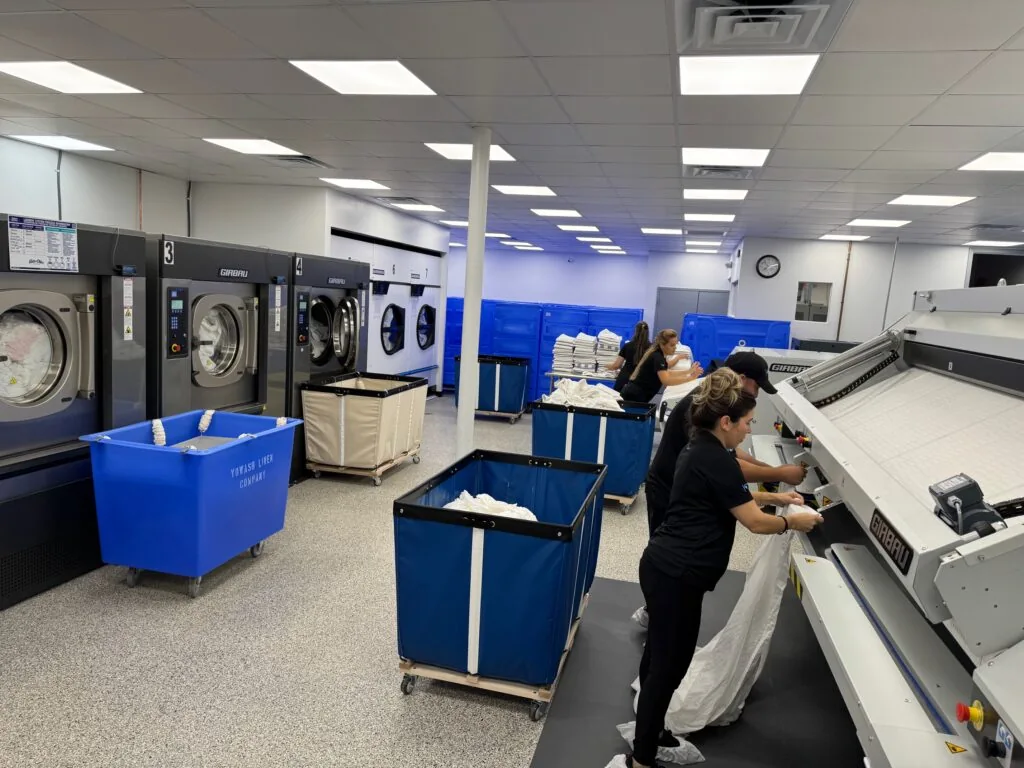 YoWash Linen team processing linens at the Sarasota facility